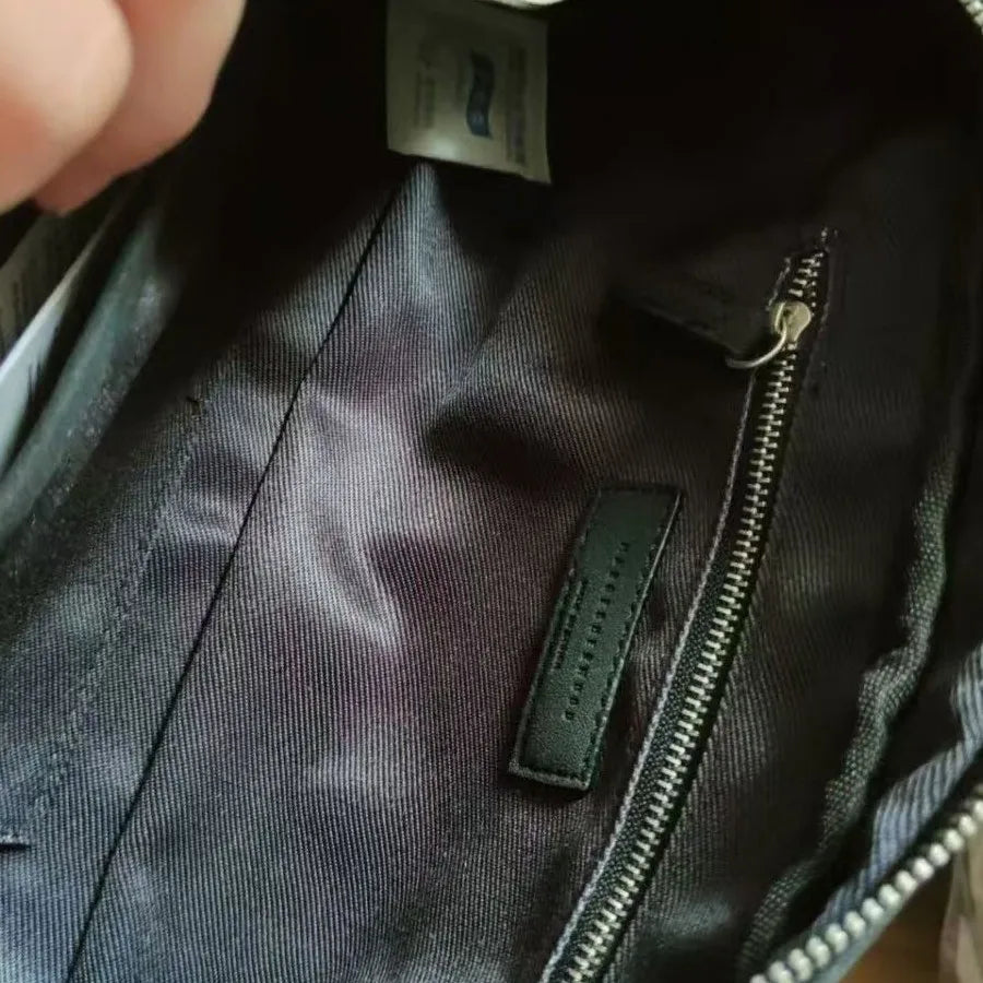 Interior of a black Korean-style tote bag featuring durable lining, a secure zipper pocket, and branded leather patch.