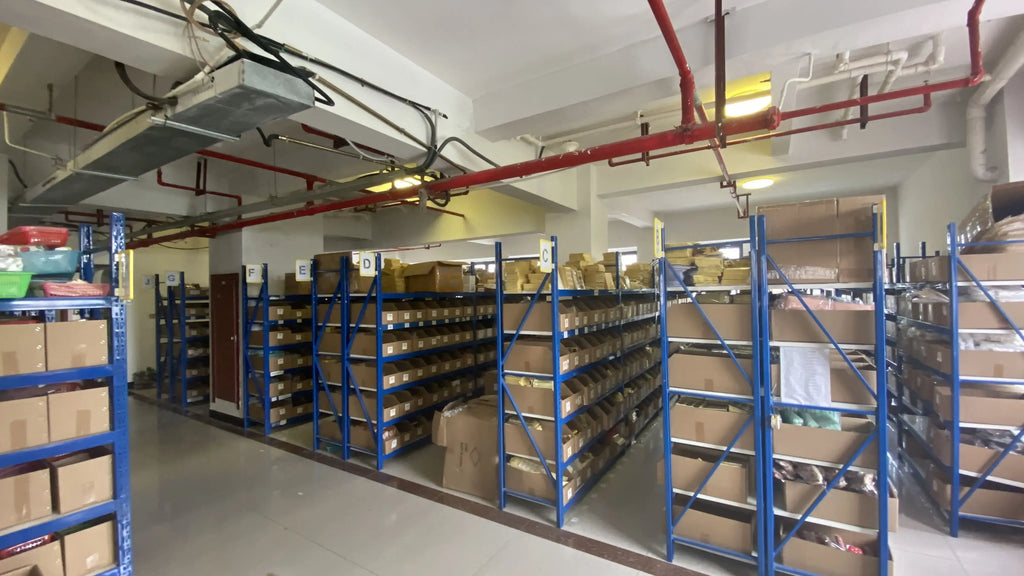 Thank-you sticker label boxes on blue warehouse shelving racks