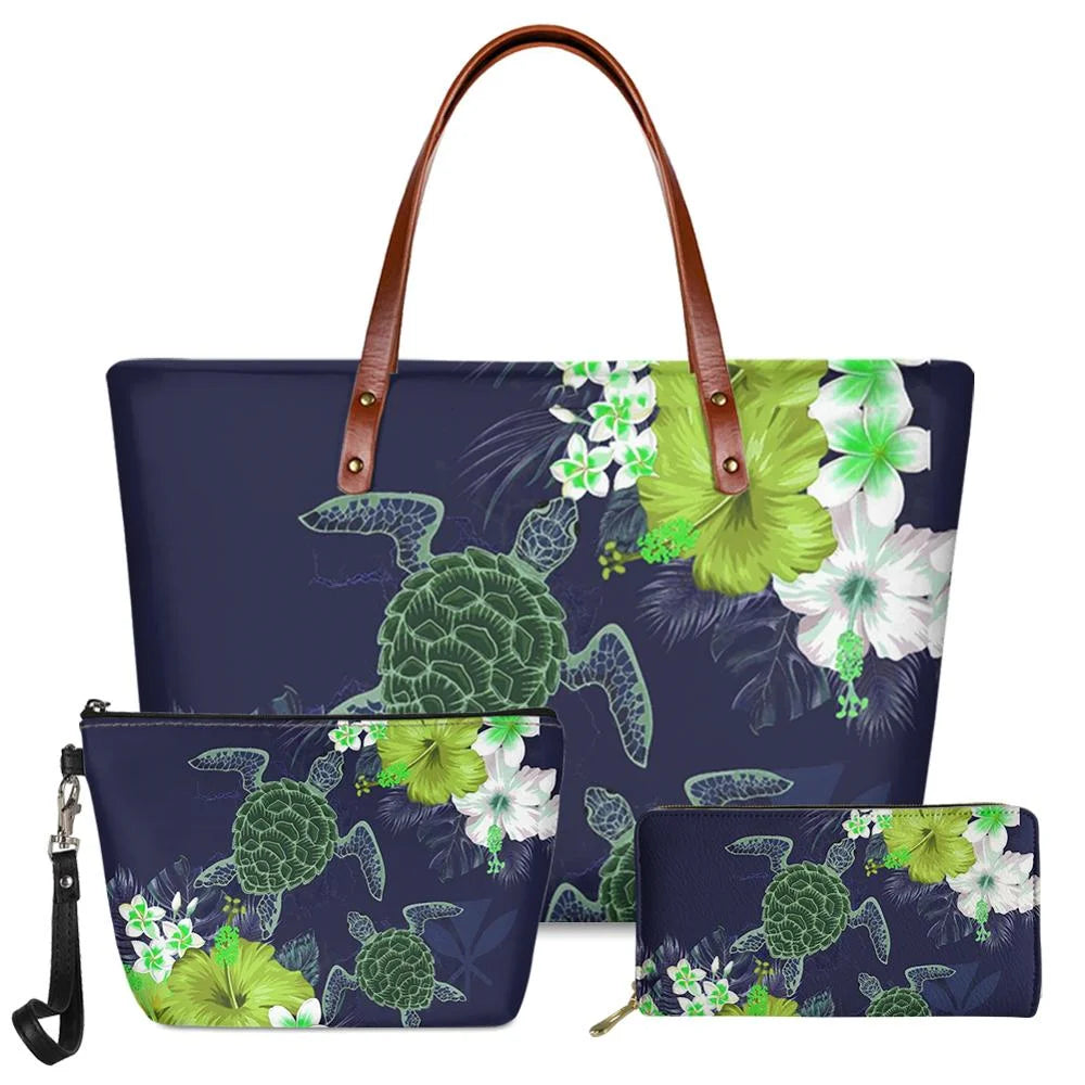 3pc navy blue handbag set with green tribal turtle and floral print, leather handles, and matching clutch and wallet.