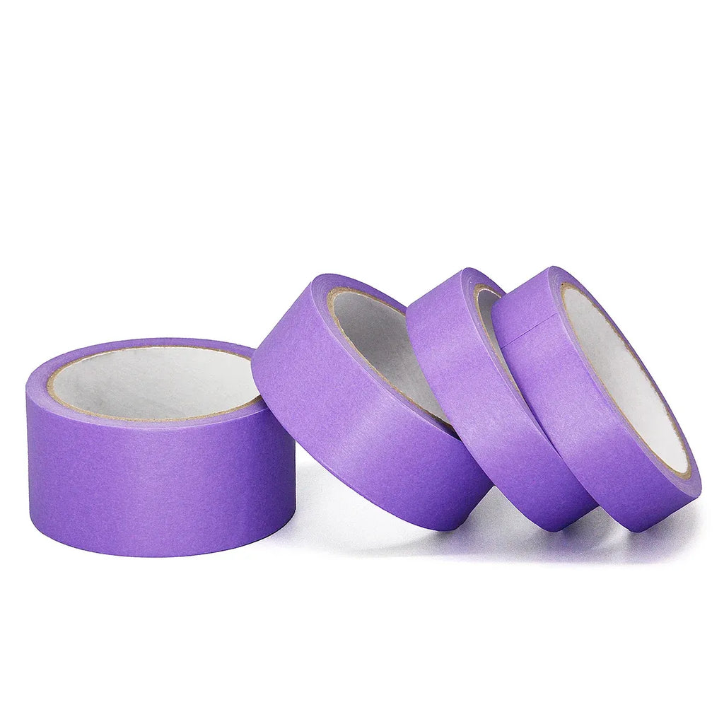 Purple masking tape rolls with paper backing, multiple rolls angled on white background.