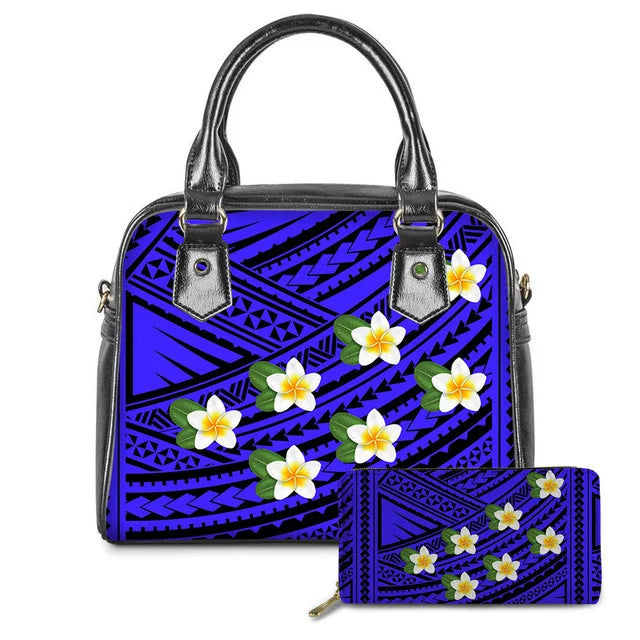 Blue leather tote bag and wallet set with black Polynesian tribal patterns and vibrant plumeria flower prints.