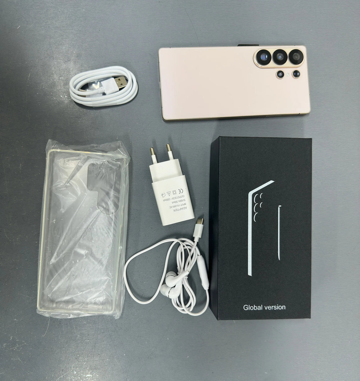 Smartphone with white back, charger, cable, and global version box with phone case