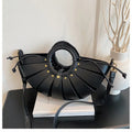 Black luxury half-moon trunk bag, hollow-out pleated design with gold studs, braided handle and detachable crossbody.