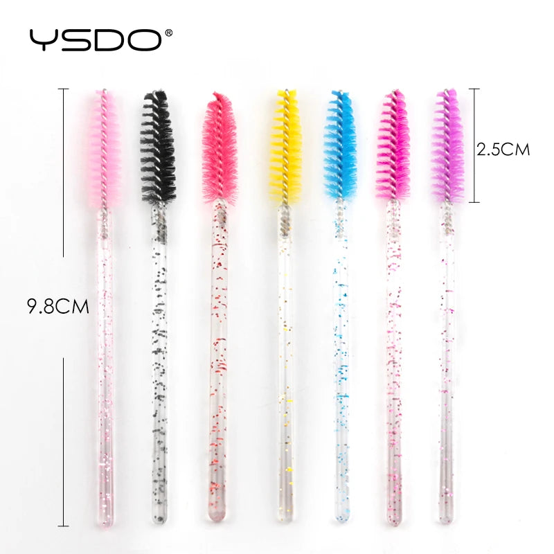 Seven disposable eyelash spoolie brushes with glittery plastic handles and multicolored nylon bristles. 9.8cm length.