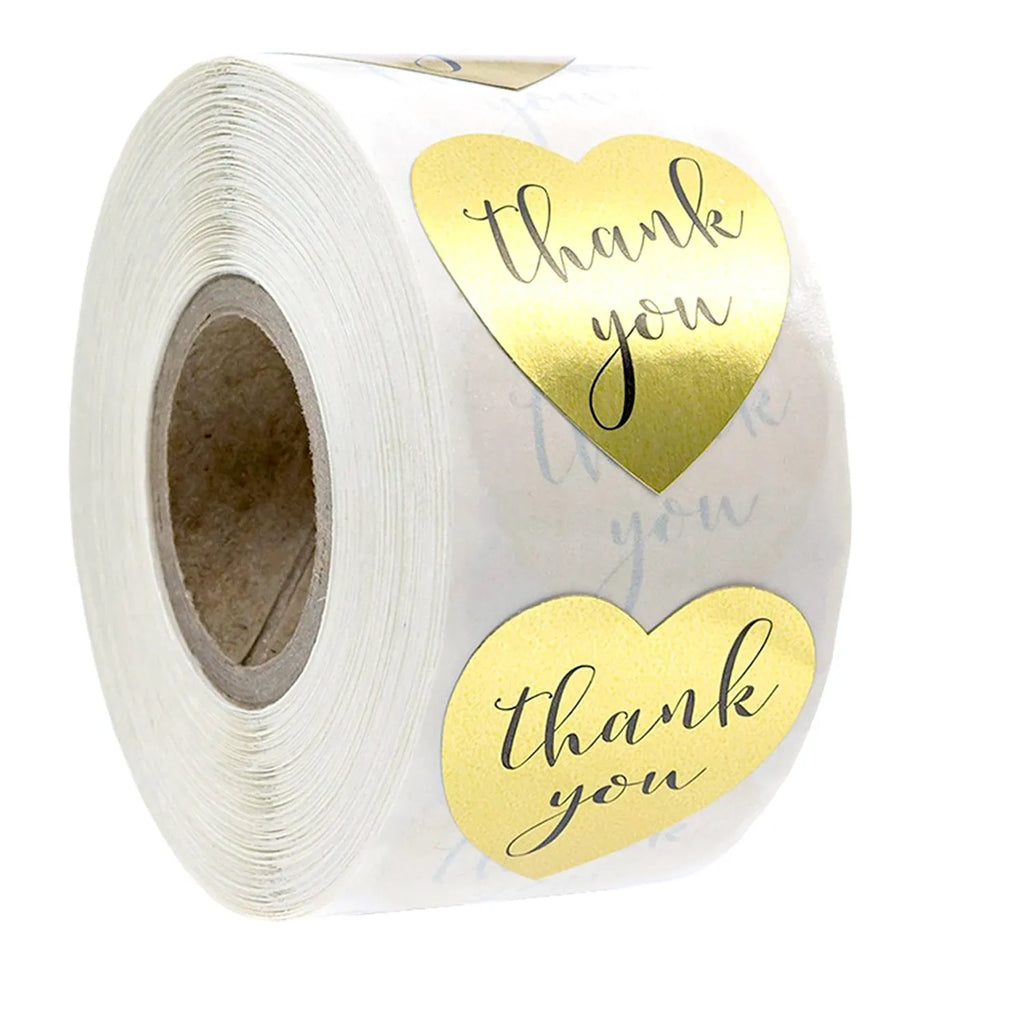 Heart thank you label stickers on a roll, gold hearts with black “thank you” text