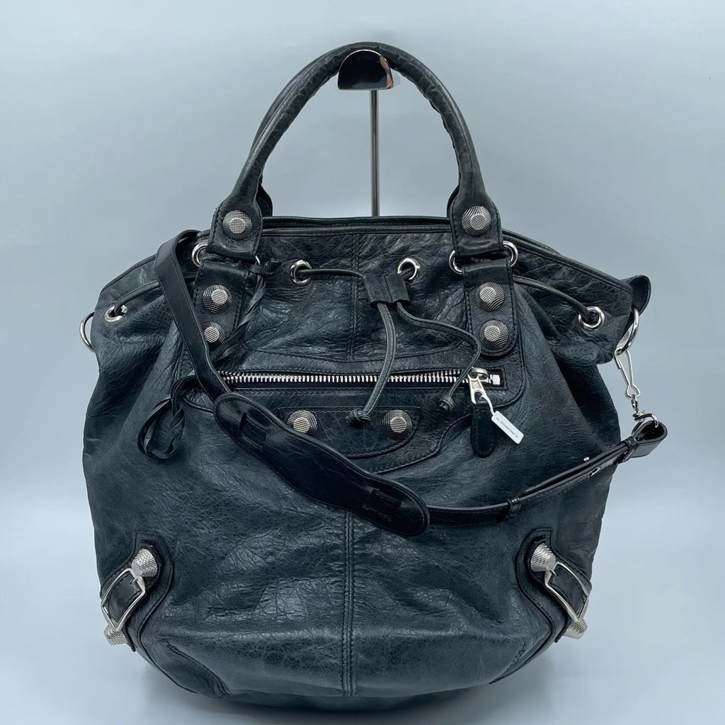 Luxury Pre-Owned Designer Leather Bucket Bag with Chic Metal Studs and Adjustable Shoulder Strap