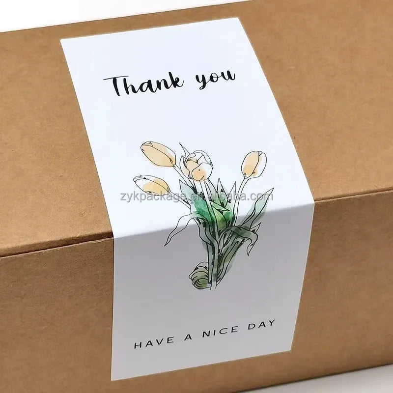 White thank you packaging sticker with tulip illustration and “Have a nice day” text.