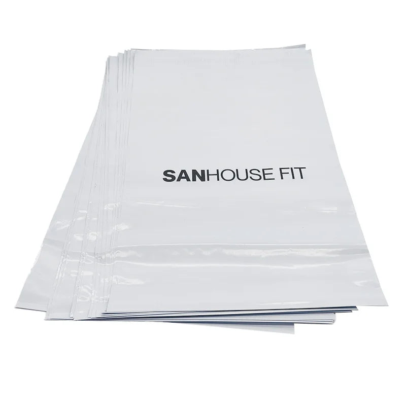 White poly mailer bags with black printed logo text, stacked multiple bags