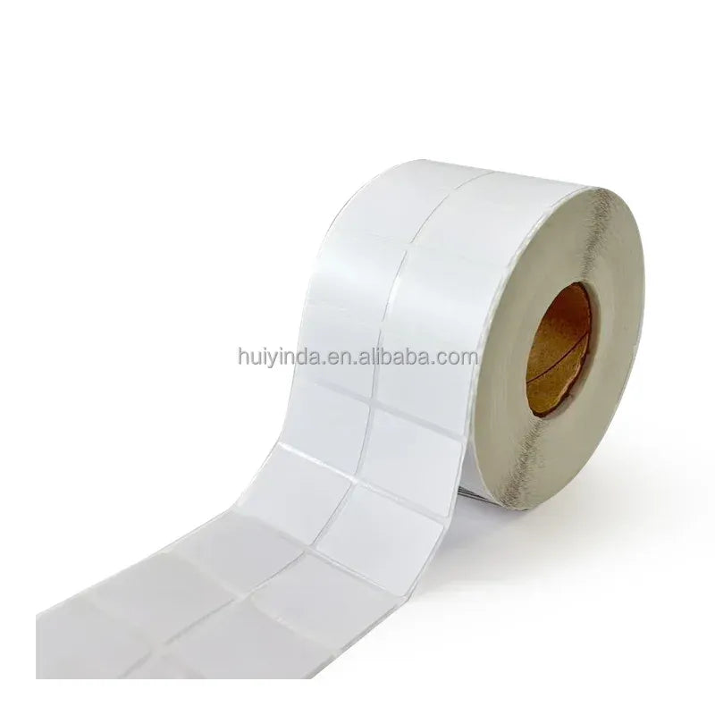 White thermal label roll with liner showing spaced label sections