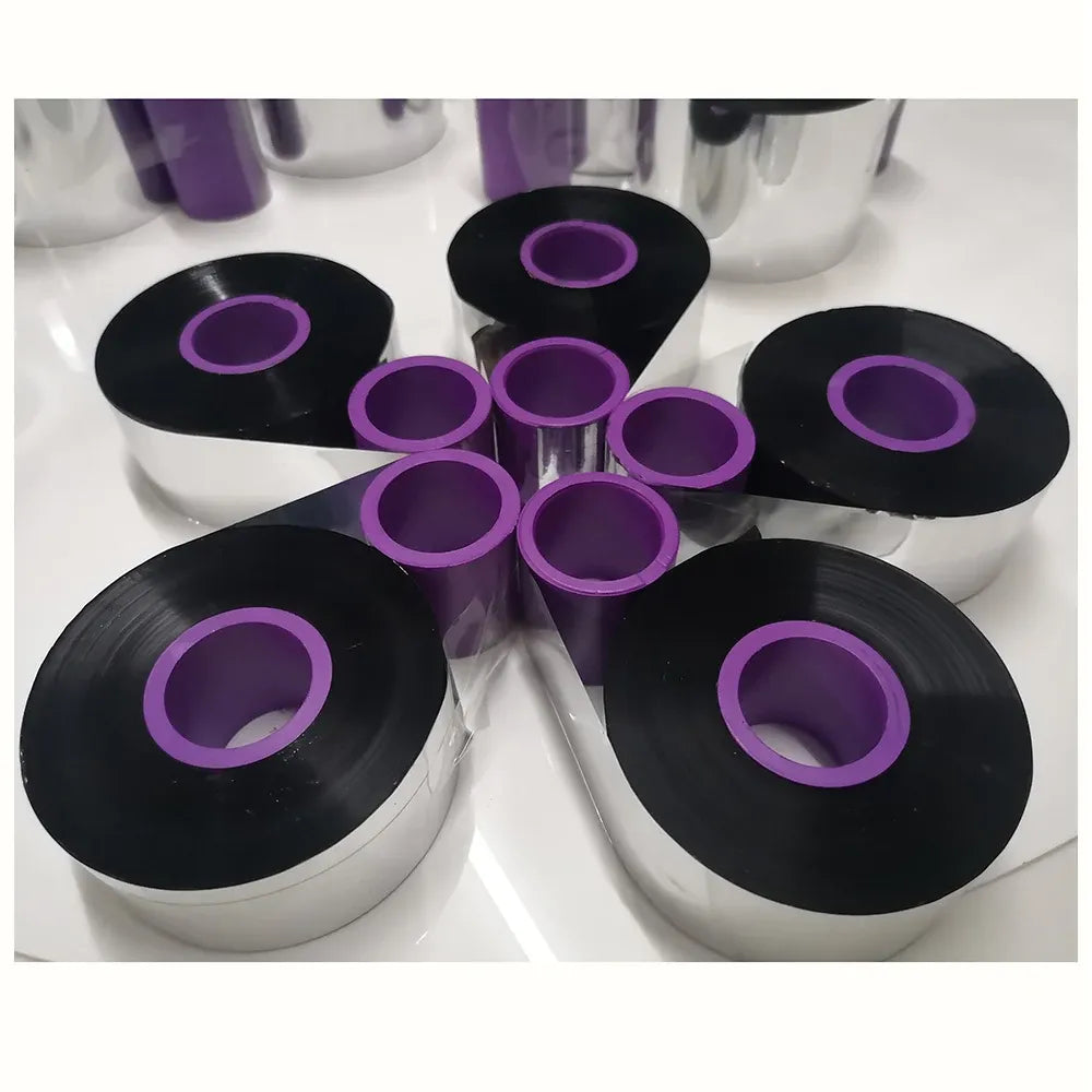 Black thermal transfer ribbon spools with purple cores arranged in a group