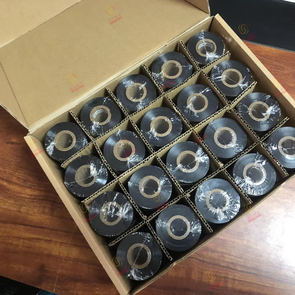 Black resin printer ribbon rolls packed in a cardboard box