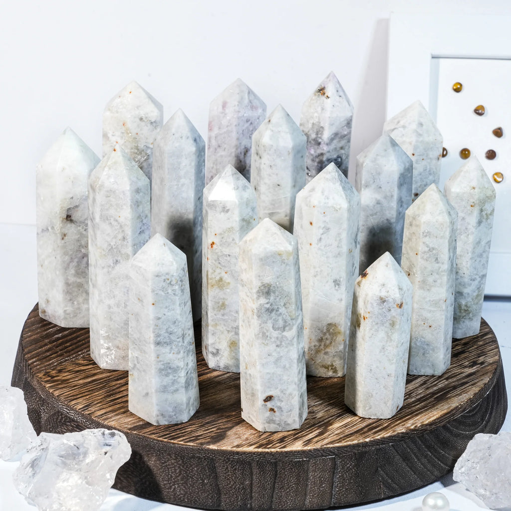 Natural gemstone crystal point tower with multiple pointed stones on a round base.
