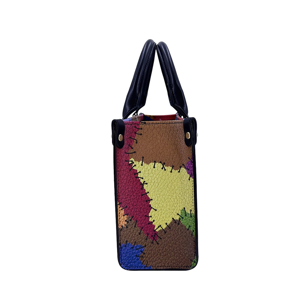 Multi-colored PU leather trunk handbag with patchwork design, stitched details, and black handles for travel.