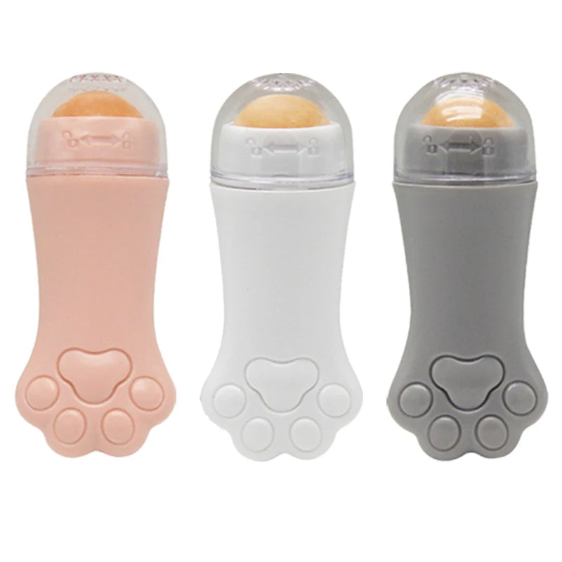 Three cat-paw shaped oil-absorbing rollers in pink, white, and gray, each with a clear cap and volcanic stone ball.