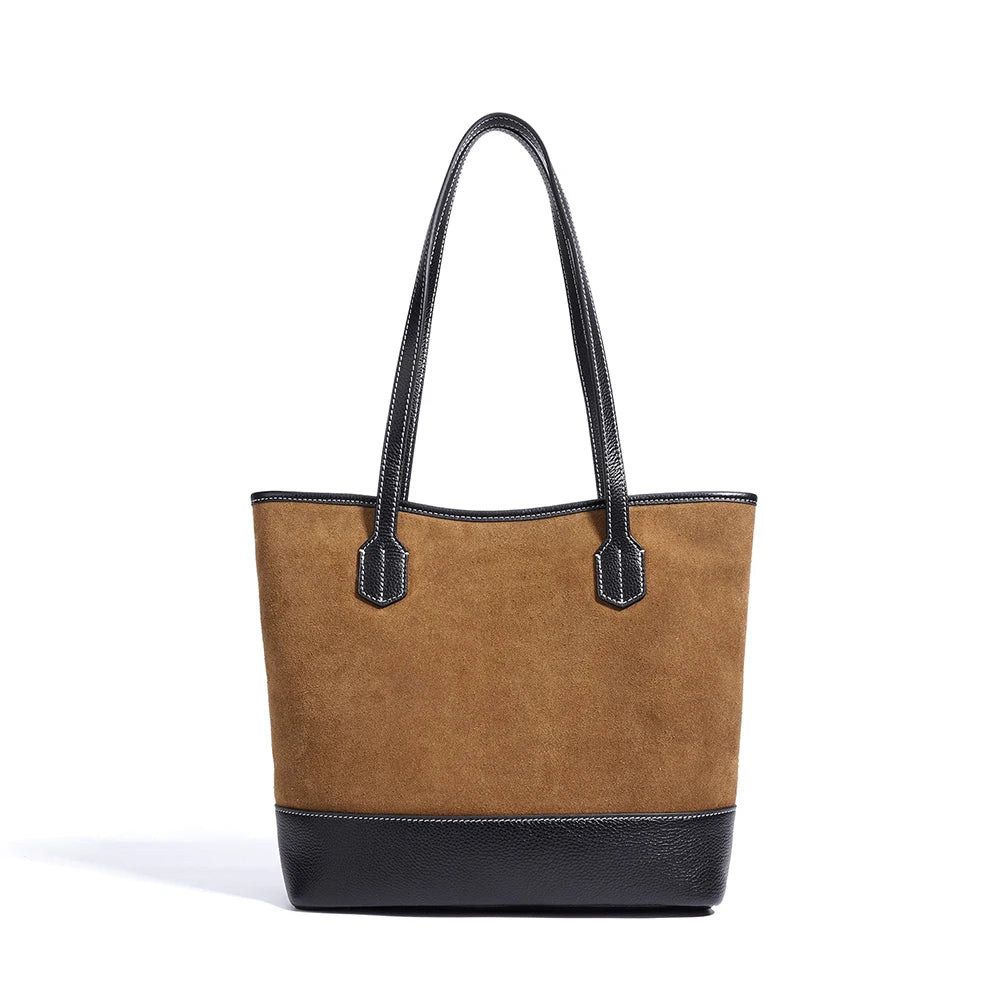 Vintage-style brown suede underarm tote bag with black pebbled leather base and long matching shoulder straps.