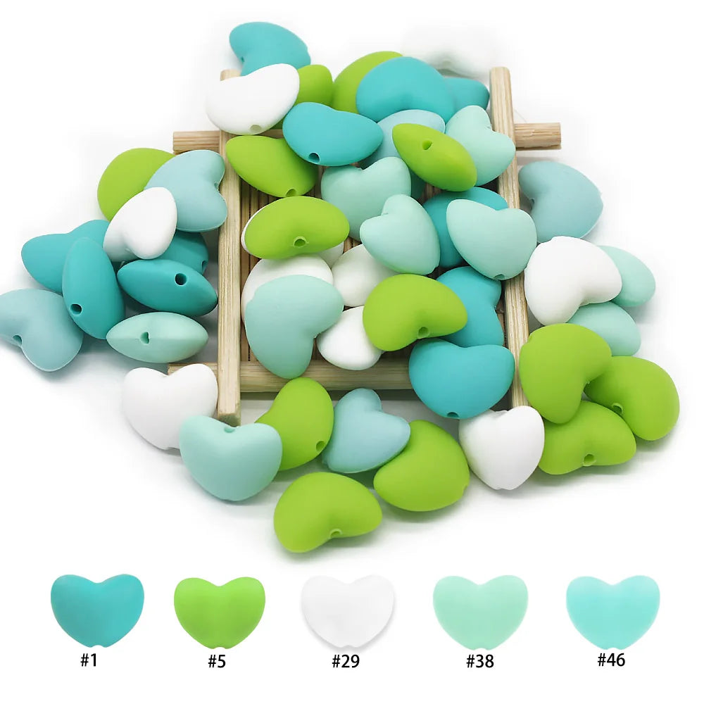 Green, blue, and white heart-shaped silicone beads for baby teething toys and DIY jewelry.