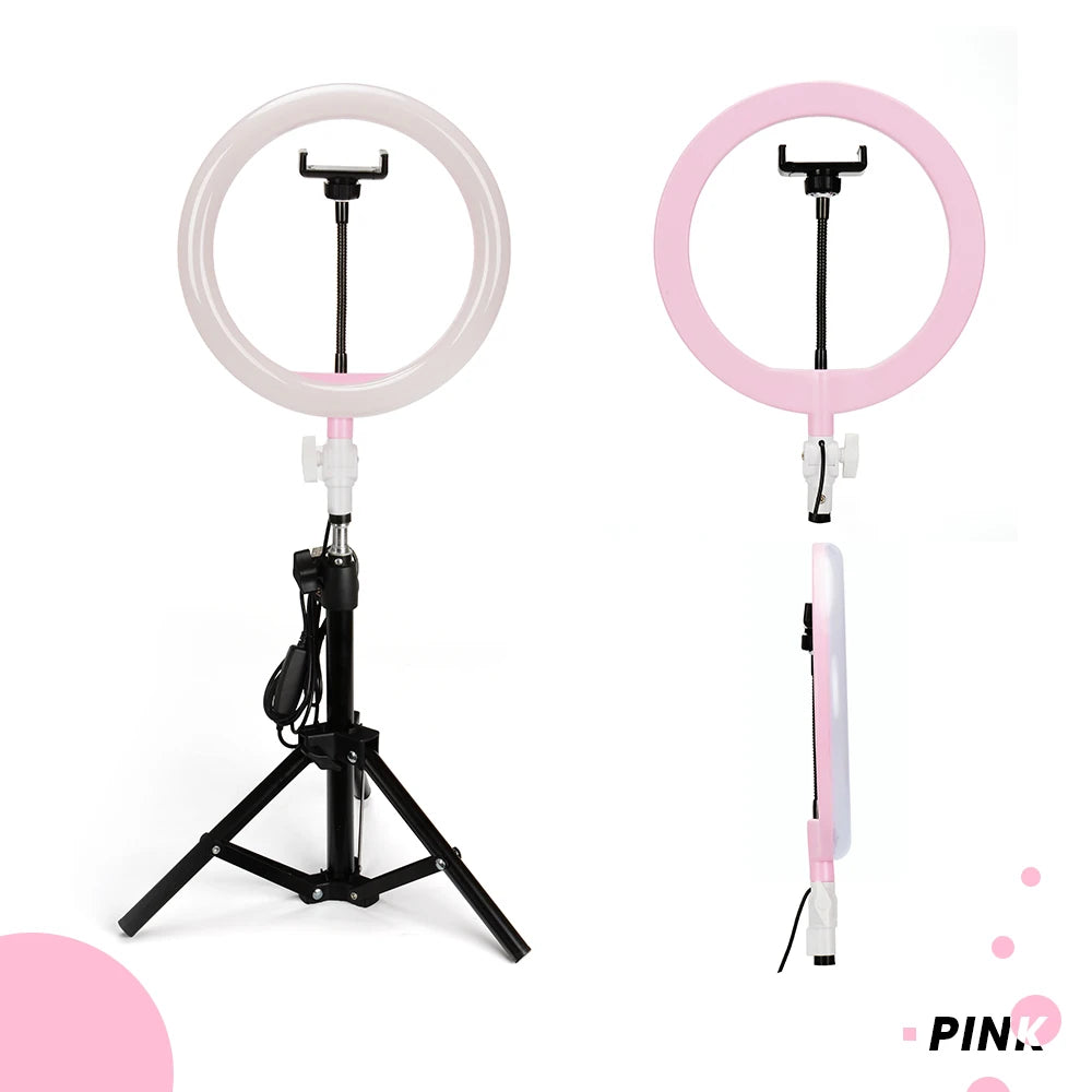 Pink ring light with a black phone mount and tripod stand, used for photography and video recording.