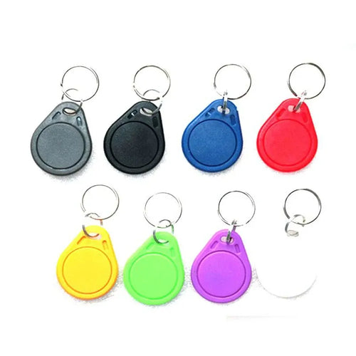 Assorted RFID key fob tags with key rings in gray, black, blue, and red