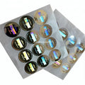 Round holographic adhesive stickers on PET sheet, black and gold reflective circles