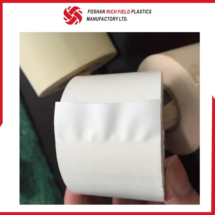 White PVC air duct tape roll with folded tape end, held in hand
