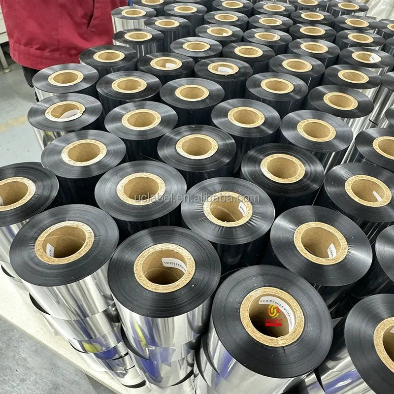 Thermal transfer wax resin ribbon rolls stacked in bulk, black with gold core