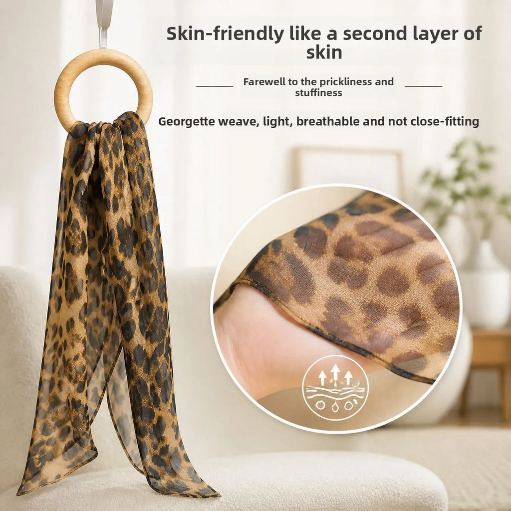 Long rectangular sheer silk georgette scarf with brown and black leopard print pattern. Luxury fashion accessory.