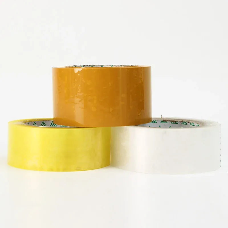 Overlapping packing tape rolls in amber, yellow, and white with printed inner labels