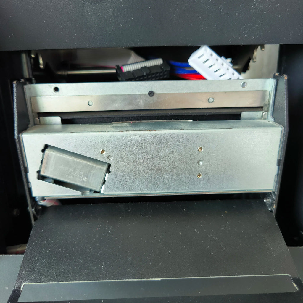 Open label printer top with metal guides and feed slot visible
