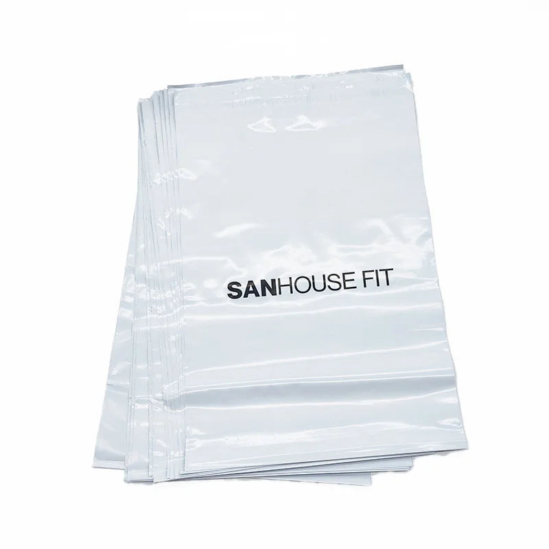White padded poly mailer bags with black printed logo text, stacked set
