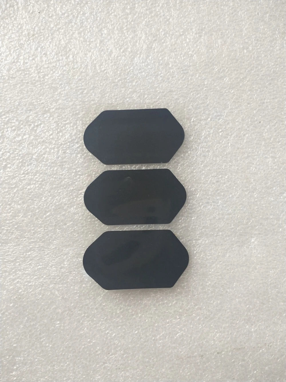 Three black replacement film stickers for 3D 4D HIFU beauty machine cartridges, hexagonal shape on white surface.