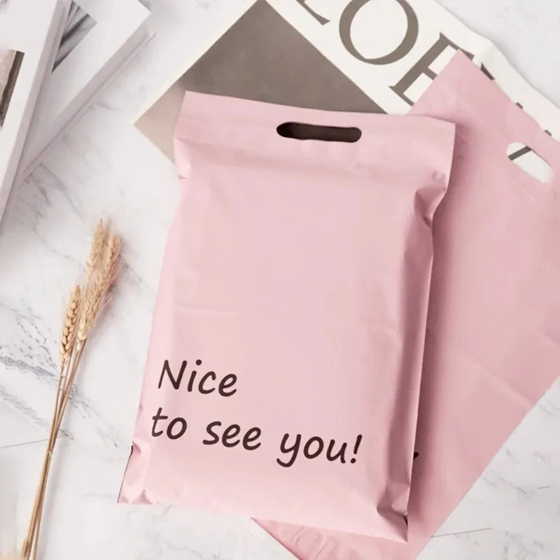 Pink poly mailer shipping bag with handle and “Nice to see you!” lettering