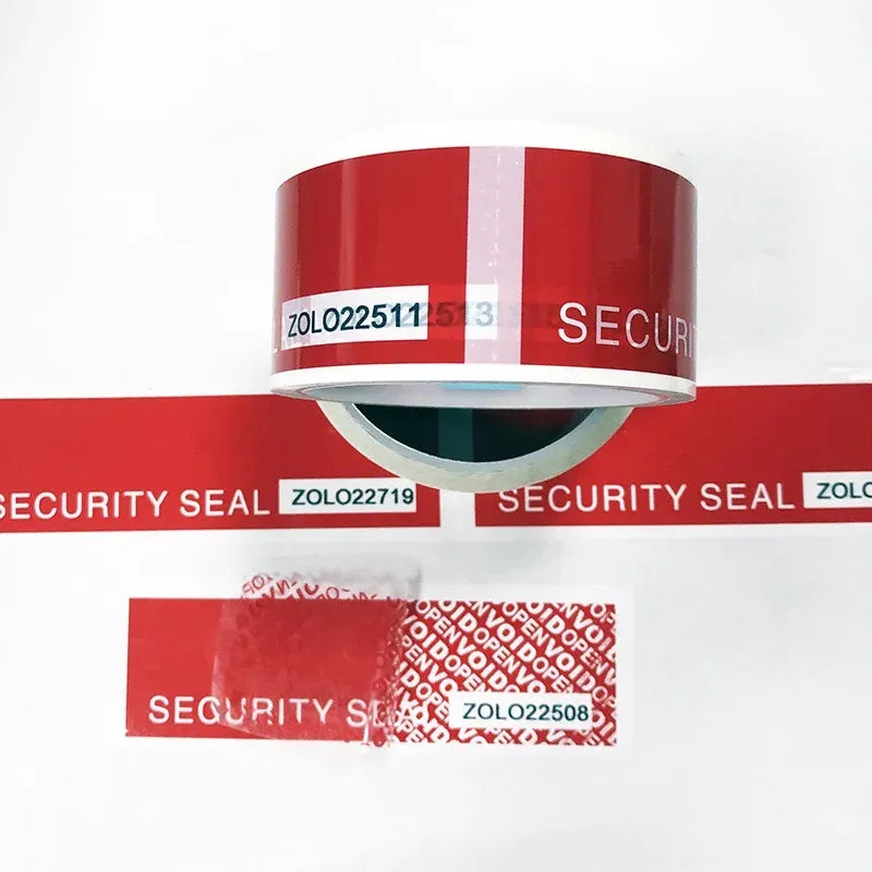 Red security seal tape roll with overlapping tamper strips and VOID pattern on surface