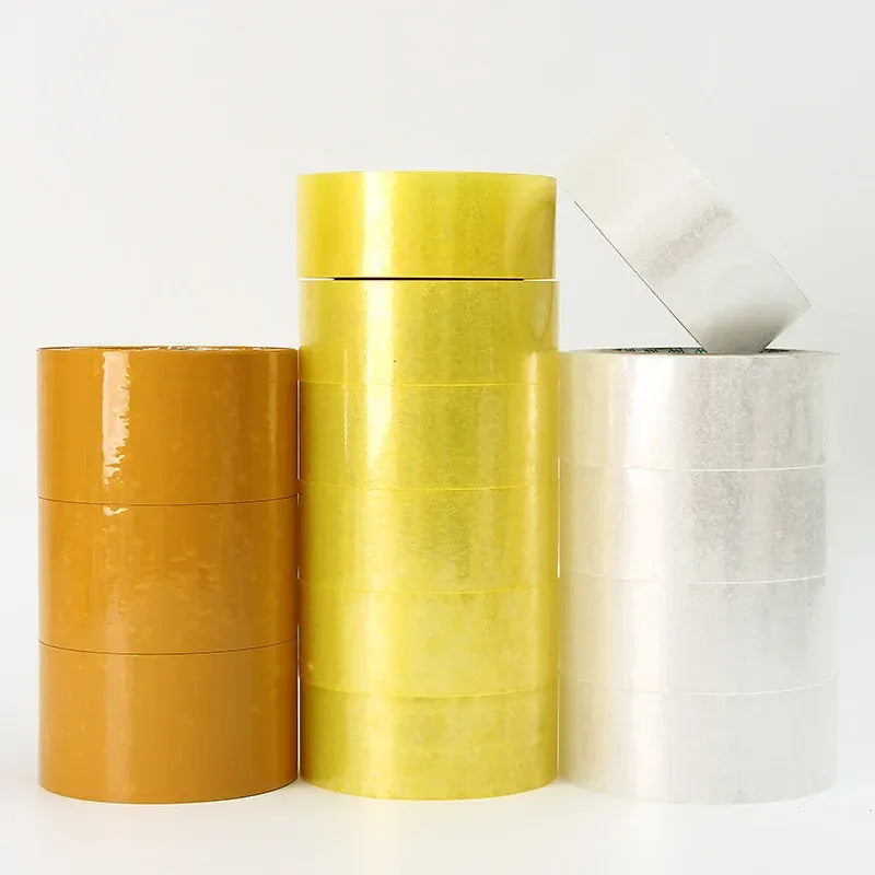 Set of packing tape rolls in amber, yellow, and white with visible printed cores