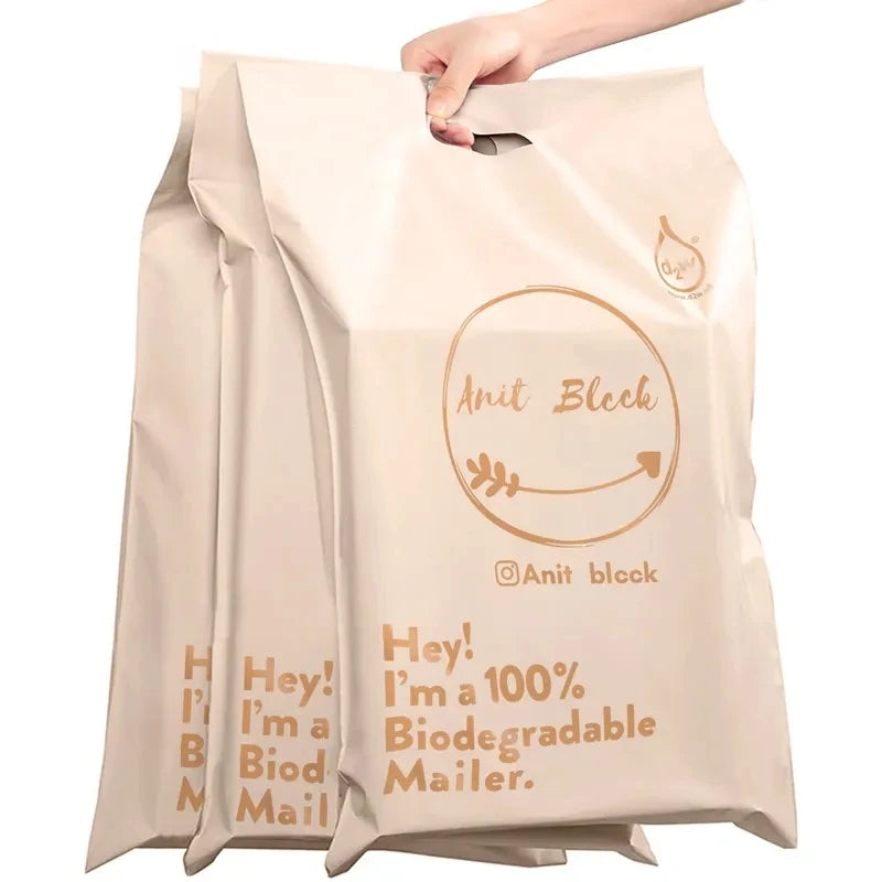Beige poly mailer envelope with handle and printed circular logo and slogan graphic