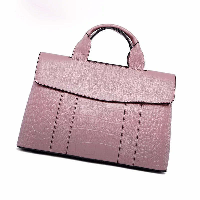 Pink genuine leather designer handbag with crocodile embossed pattern, top handle, and elegant flap closure.