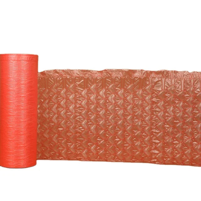 Pink bubble wrap mailer roll with textured air cushioning sheet, curled for packing
