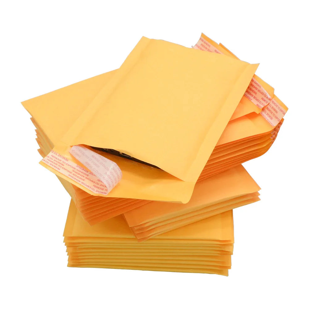 Yellow padded mailing bags stacked over orange cushioned layers