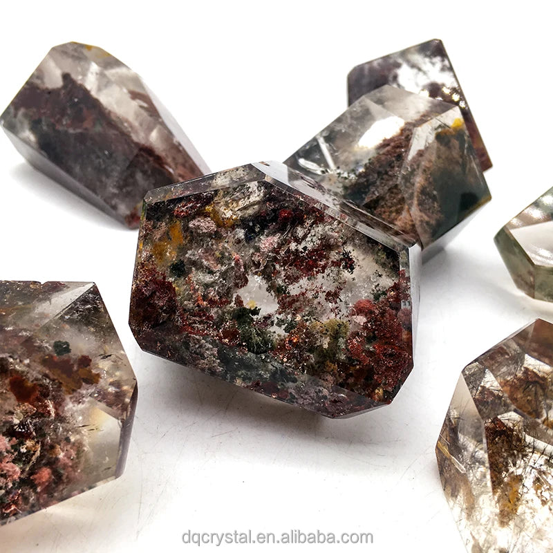 Quartz crystal freeform set with dark burgundy speckled inclusions, faceted blocks