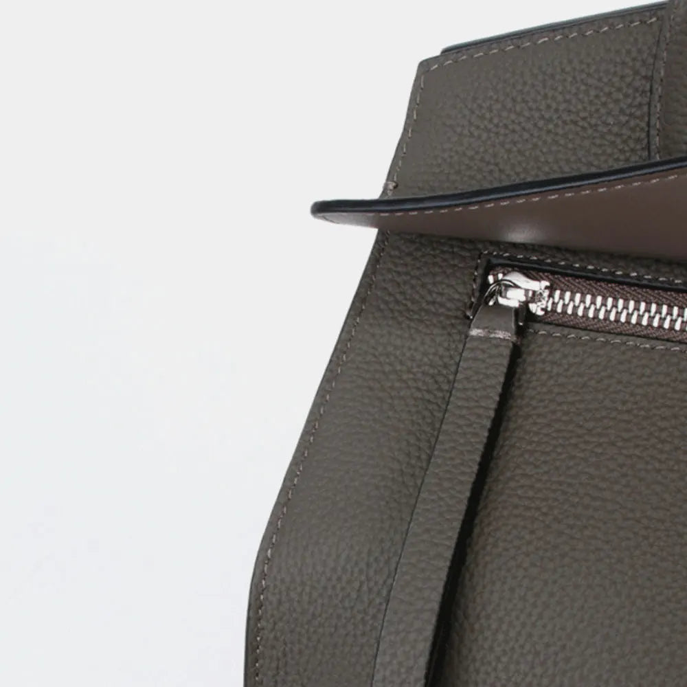 Grey pebbled genuine leather luxury trunk tote bag with silver metal zipper detail and premium stitching.