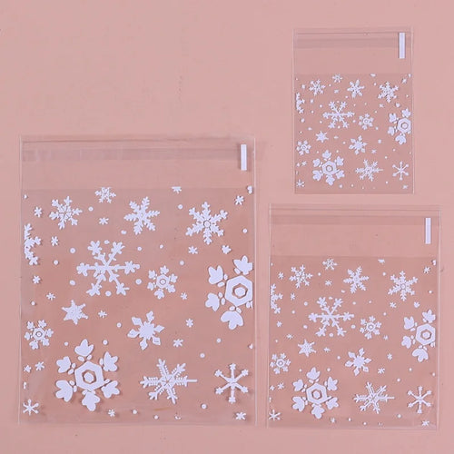 Clear self-adhesive resealable treat bags with snowflake prints, two bags with tabs