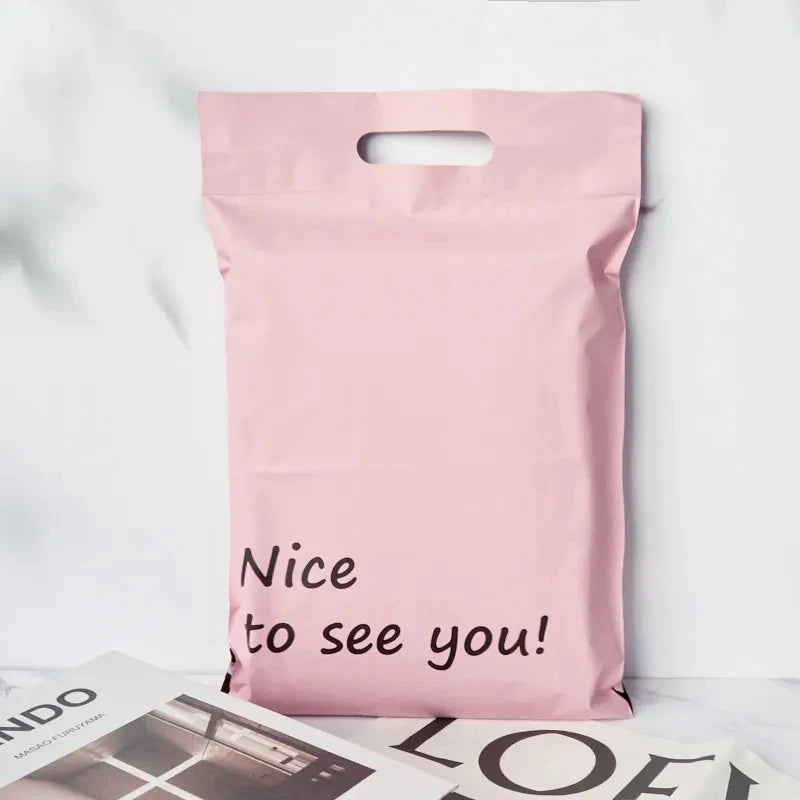 Pink poly mailer shipping bag with handle and “Nice to see you!” graphic text