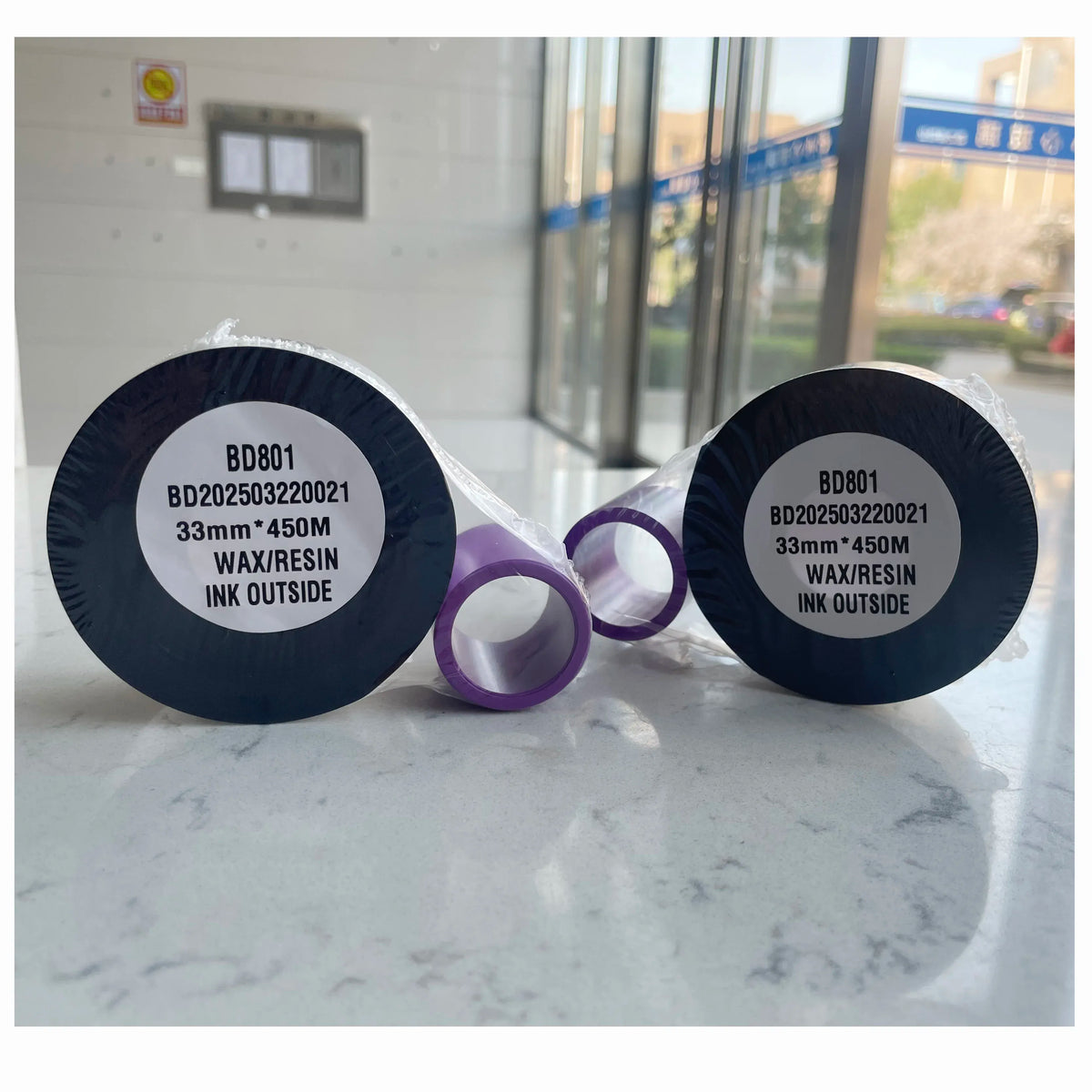 TTO ink coding ribbon spools with black cores and purple ribbon band, front labels