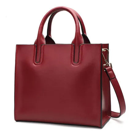 Red vintage leather tote bag with top handles and detachable shoulder strap for casual everyday use.