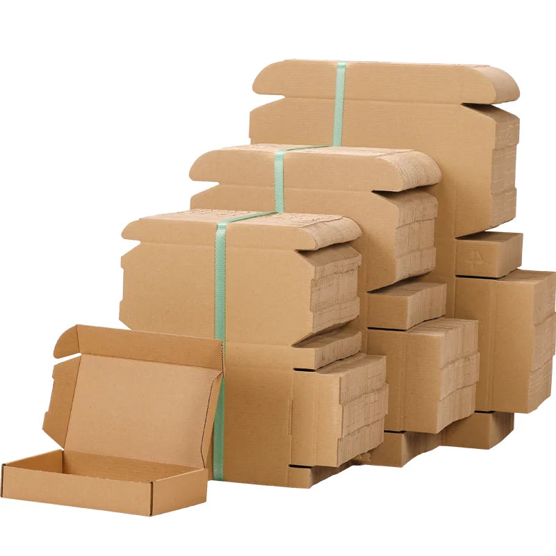Stacked brown kraft shipping boxes bundled with teal straps, multiple sizes