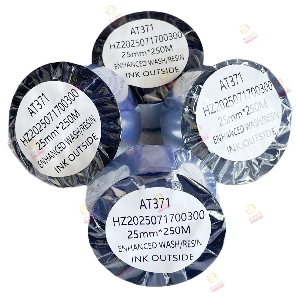 Bundle of black resin ribbon spools with printed AT371 info labels