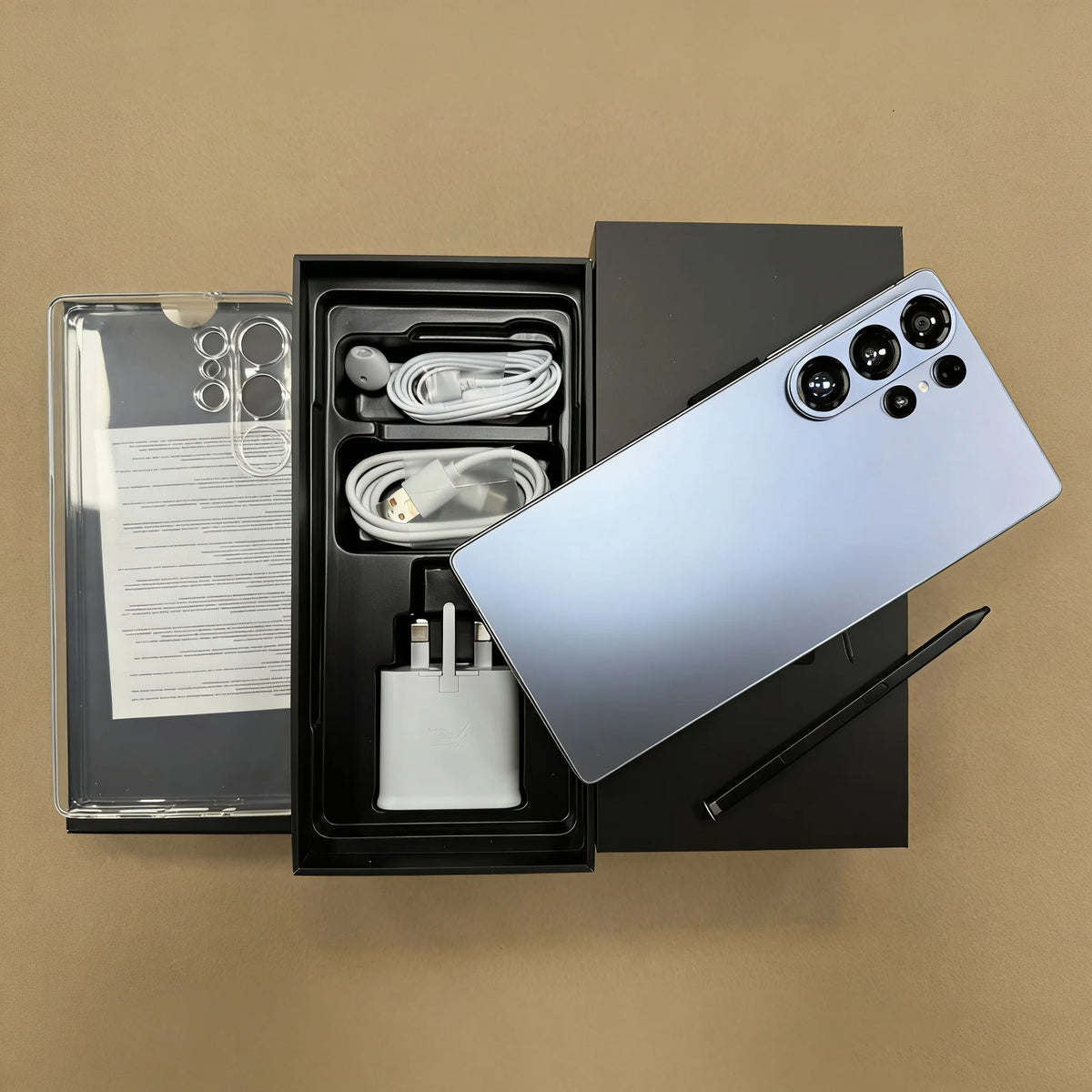 Unboxed S26 Ultra 5G smartphone set: phone back, cables, charger, and manual in box.