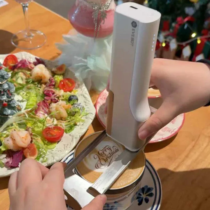 Handheld inkjet printer with white body held above coffee plate