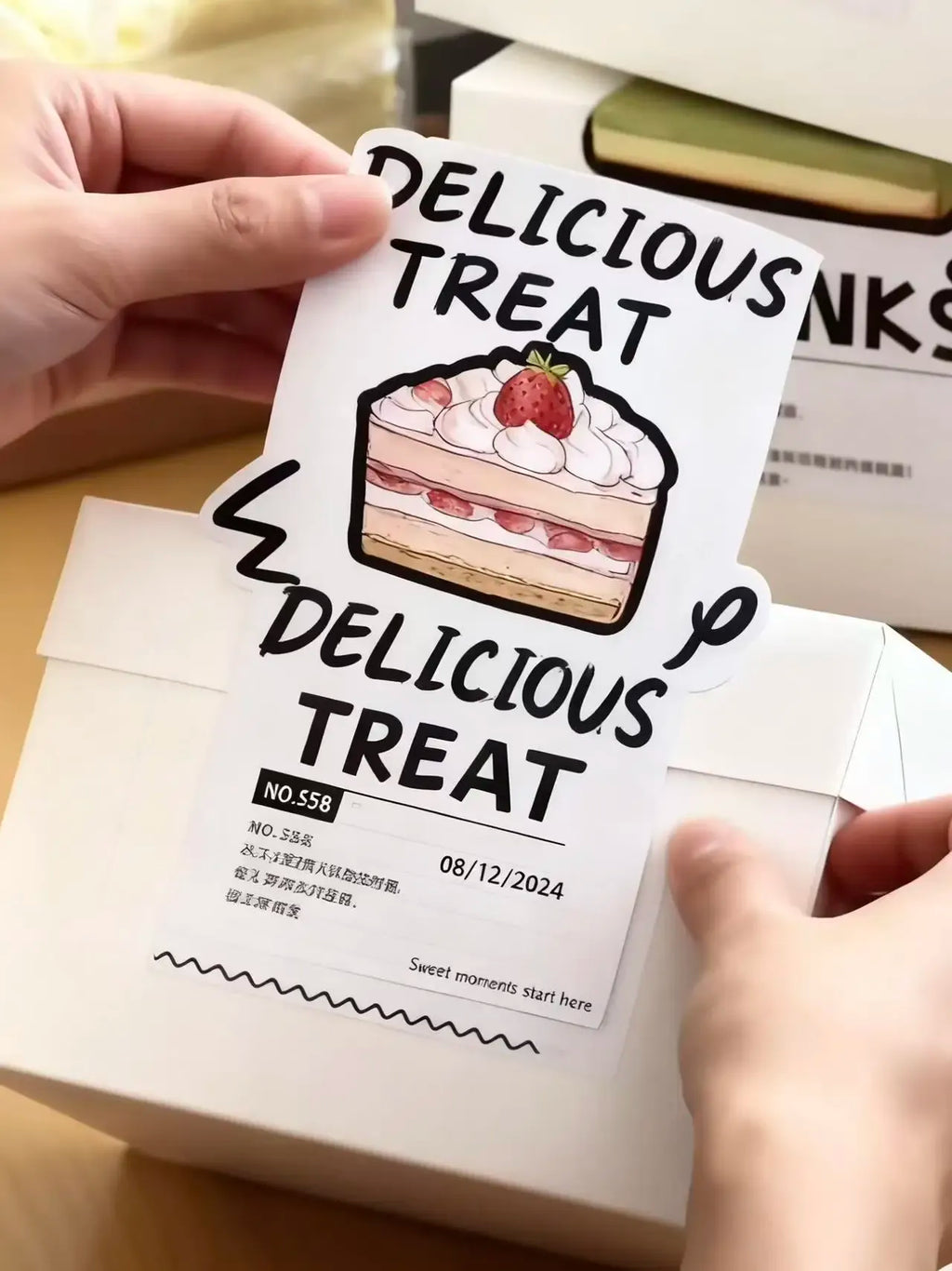 Delicious treat logo PVC sticker label on dessert box with hands