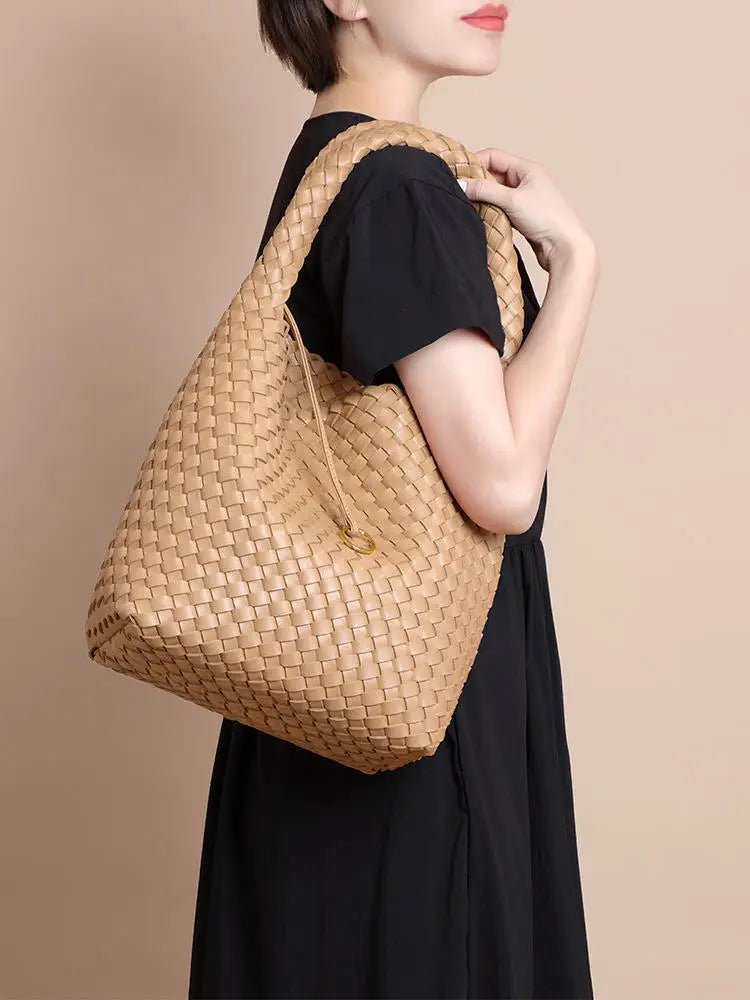 Beige woven PU leather hobo bucket bag with a braided shoulder strap, stylish slouchy design for casual daily use.