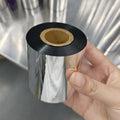 Black resin thermal transfer ribbon roll on hand-held spool, cardboard center